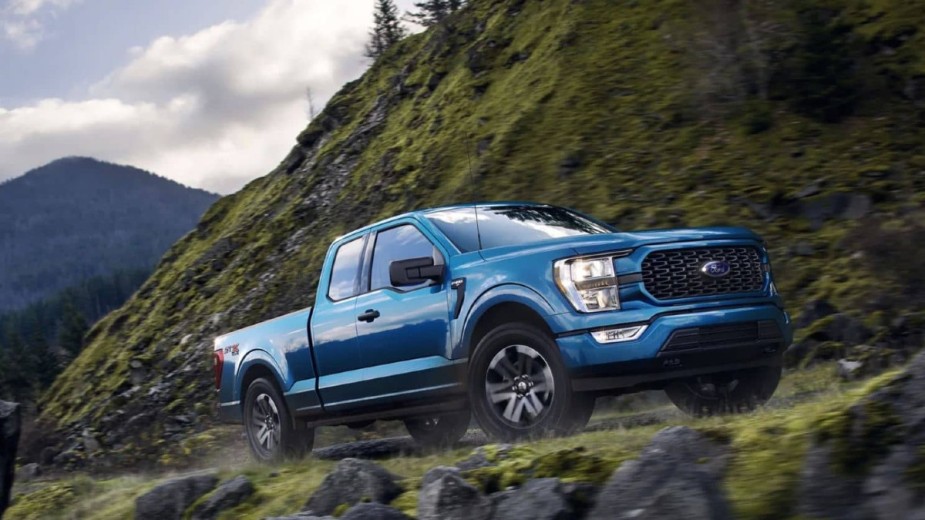 Ford F-150 blue 2022 on a mountain road