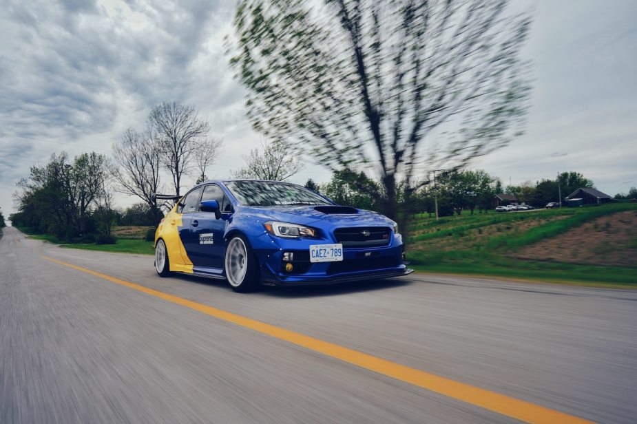 A blue Subaru prepares for street racing