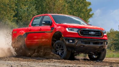 A red 2023 Ford Ranger is driving off-road.