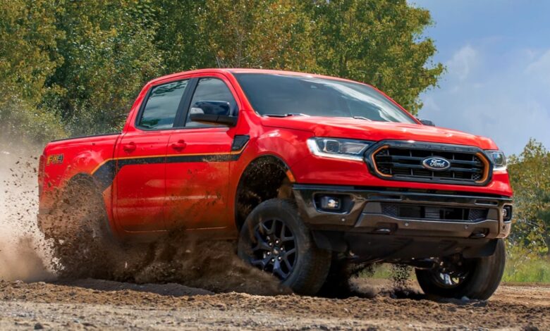 A red 2023 Ford Ranger is driving off-road.