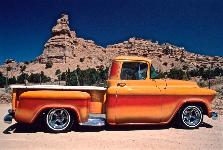 This orange truck was dropped in a big way, and stopped in the desert in front of some cliffs.