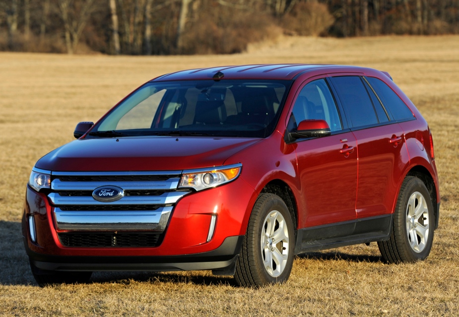 A red 2012 Ford Edge parked outside on the grass, it's a model year Ford SUV to avoid