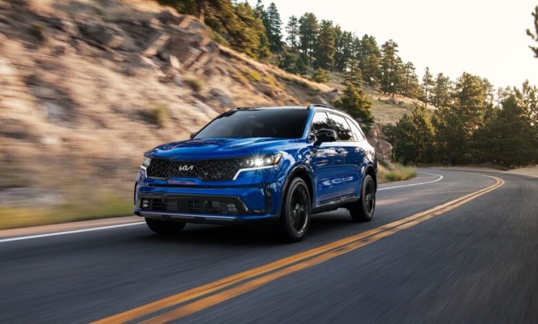 2023 Sorento SX in blue driving down the road