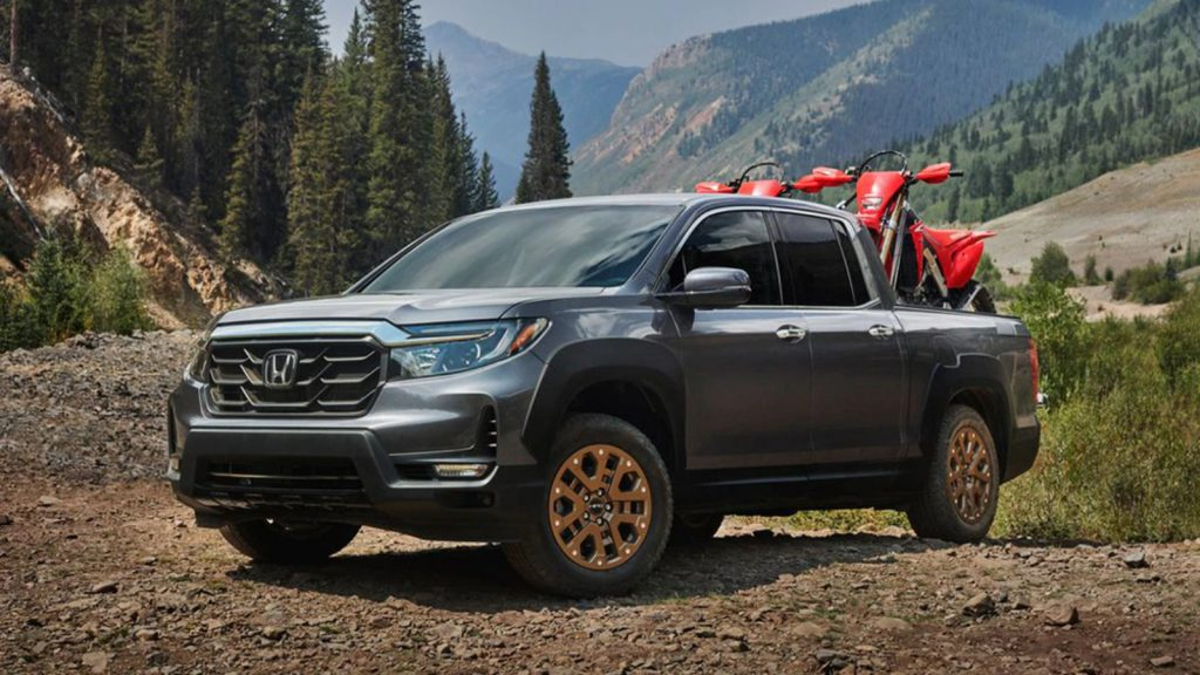The 2022 Honda Ridgeline pulls a pair of motorcycles in its bed.