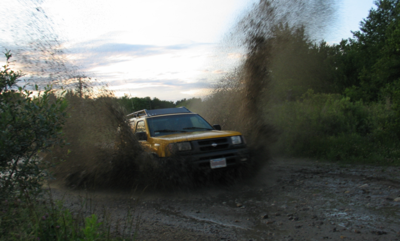 A yellow Nissan Xterra demonstrates its off-road ability.