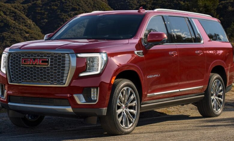 A red 2023 GMC Yukon XL full-size SUV is parked.