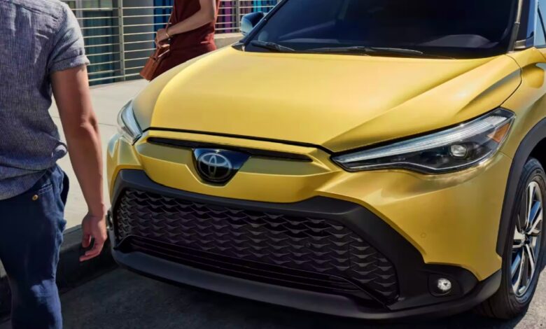 The front of a gold 2023 Toyota Corolla Cross Hybrid subcompact hybrid SUV.
