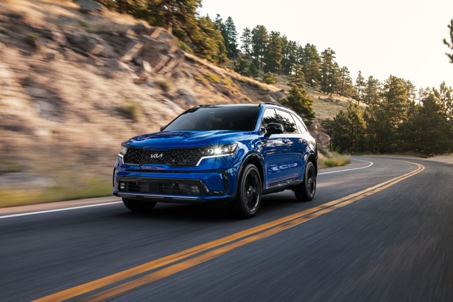 2023 Sorento SX in blue driving along the road