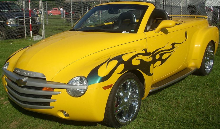 A yellow Chevy SSR pickup truck with flames on the side.