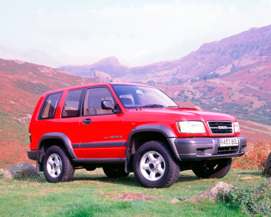 A red Isuzu Trooper sits in a remote location like an off-road SUV.