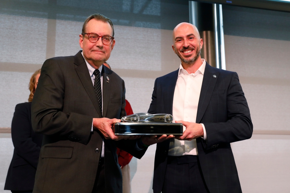 Emile Courcourt, Assistant Vice President of Acura National Sales, accepts the award presented by Jacques Nerad.