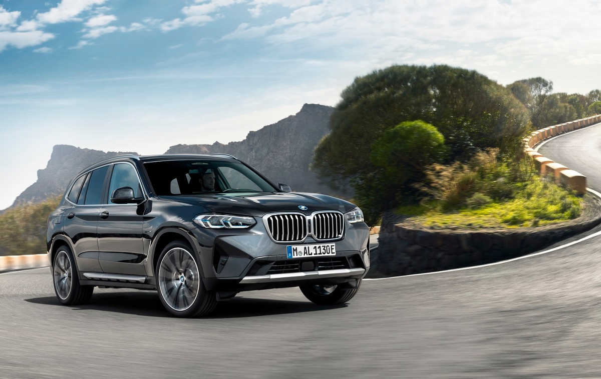 a gray BMW x3 on a winding road