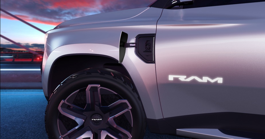 Close up of Ram Revolution door badge and front bezel, sunset visible in the background.