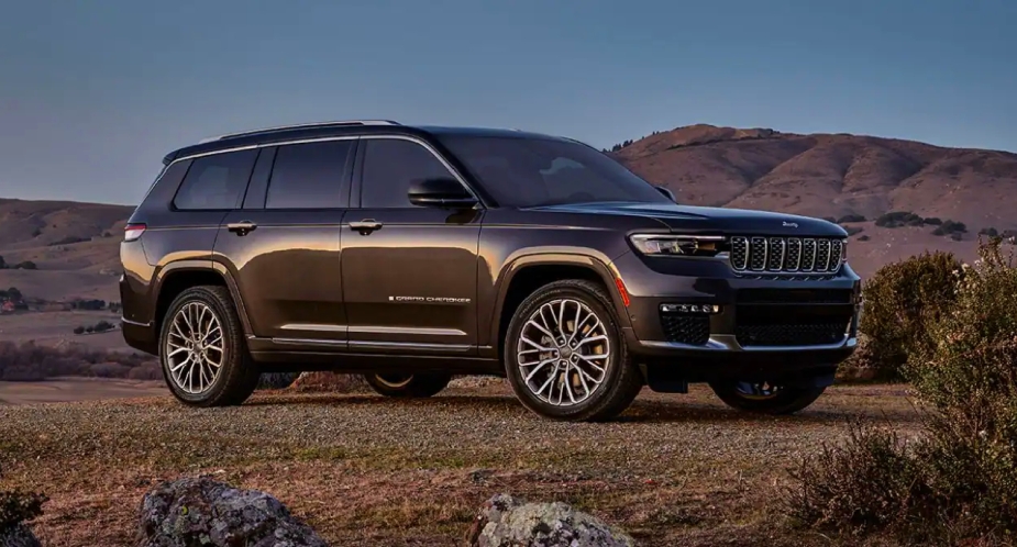 A green 2023 Jeep Grand Cherokee midsize SUV is parked outdoors. 