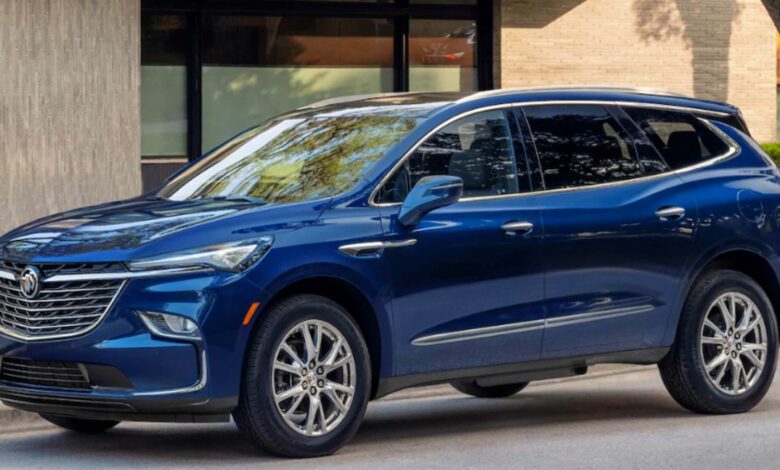A blue Buick Enclave midsize SUV is parked on the road.