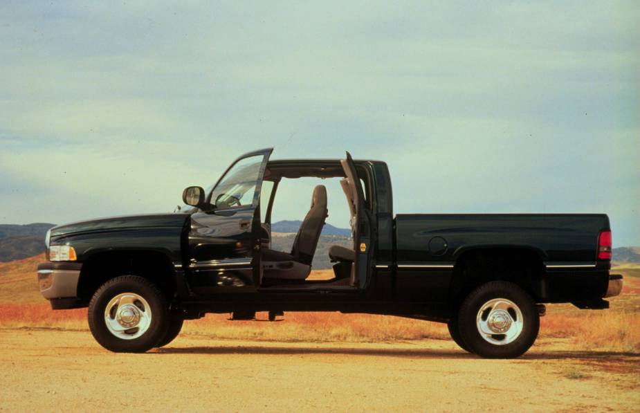 A black 1998 Dodge Ram pickup truck with its rear-hinged doors opens to reveal its quadruple rear seat.
