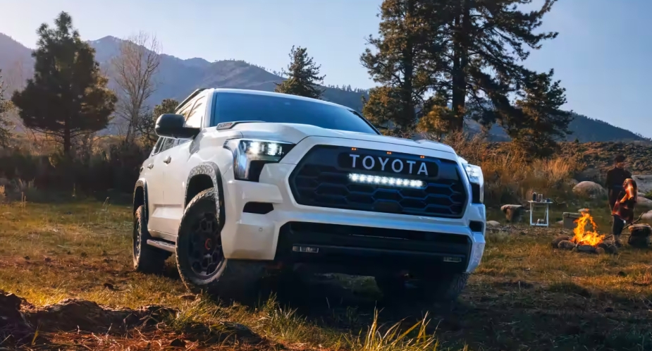 A white 2023 full-size Toyota Sequoia SUV is parked outdoors. 