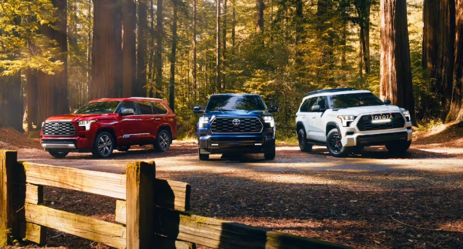 Three full-size 2023 Toyota Sequoia SUVs are parked outside. 