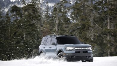 The Ford Bronco Sport driving through a snowy field