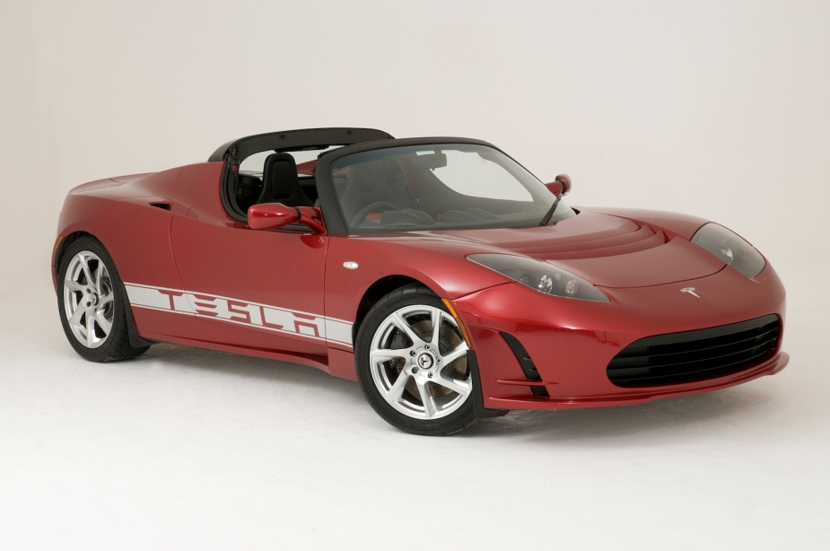 A promotional photo of a red Tesla supercar parked against a white background.