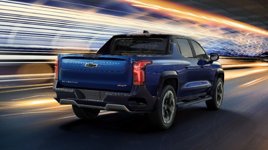 Rear corner view of a blue Chevy Silverado EV highlighting Chevy's new electric pickup truck topping the Ford Maverick 