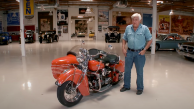Jay Leno stands next to the 1940 Indian motorcycle he crashed in January 2023
