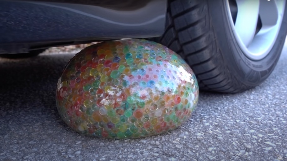 A tire goes over Orbeez's water balloon in a viral YouTube video showing a car crushing soft, crunchy objects
