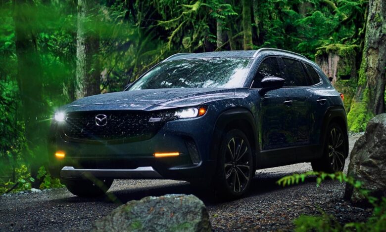 A blue 2023 Mazda CX-50 small SUV is parked off-road.