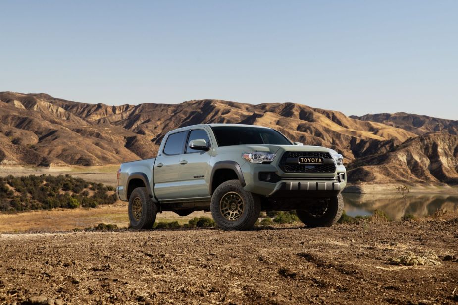 A 2023 Toyota Tacoma Trail midsize pickup truck is parked on plowed ground