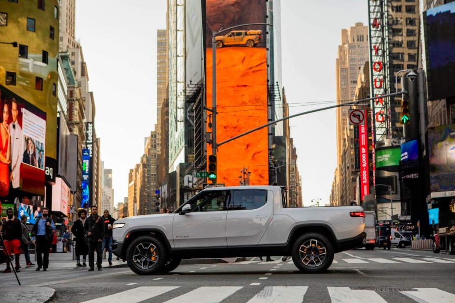 A White Rivian R1T electric pickup truck is parked in Times Square, New York City for the company's Wall Street IPO.
