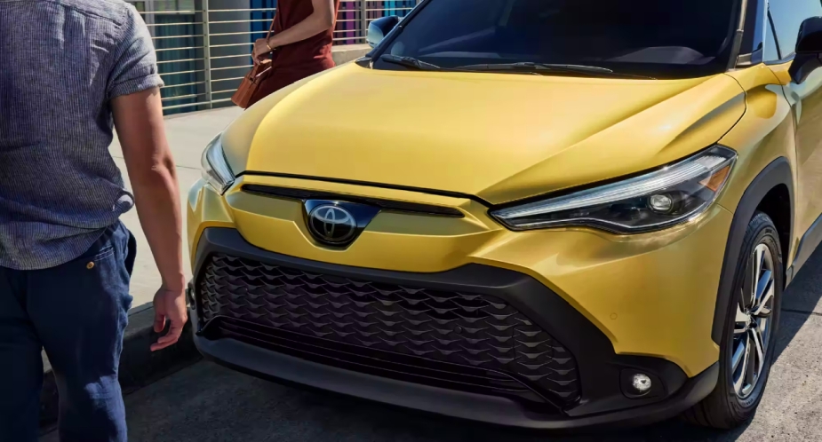 The front of a gold-colored 2023 Toyota Corolla Cross Hybrid subcompact hybrid SUV.
