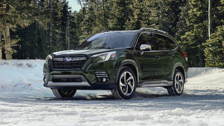 Green 2023 Subaru Forester crossover SUV parked on a snowy street