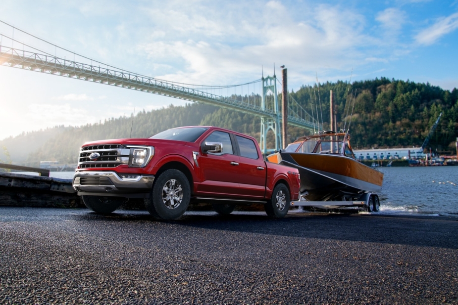 A red 2023 Ford F-150 towing a trailer is named Edmunds' top-rated truck
