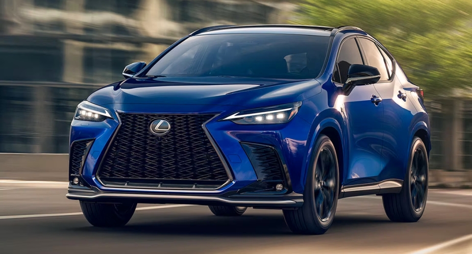 A blue 2023 Lexus NX 350h small luxury hybrid SUV is driving on the road. 
