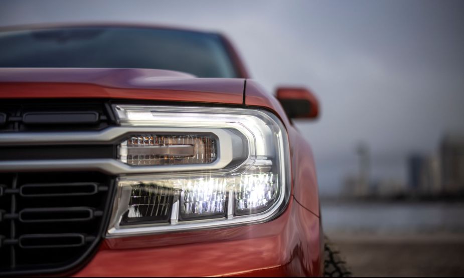 Close-up of the grille and headlights of a red 2022 Ford Maverick Lariat pickup truck