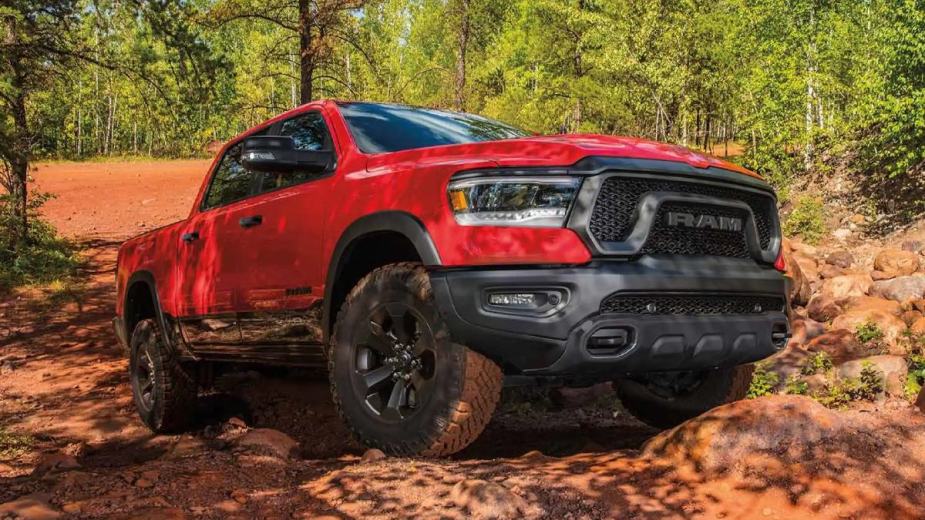 Front corner view of a red 2023 Ram 1500, a new full-size pickup truck only recommended by Consumer Reports in 2023