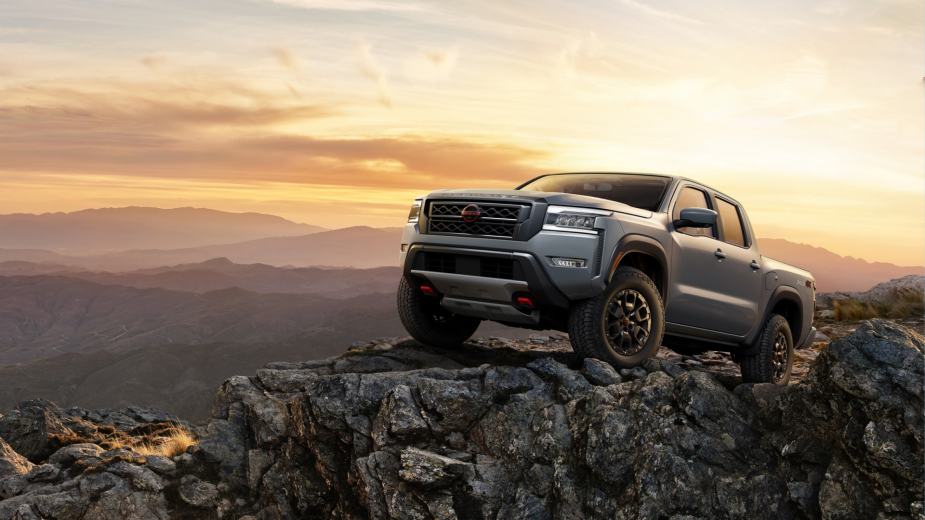 This gray 2023 Nissan Frontier Pro 4X sits on a rocky hill.