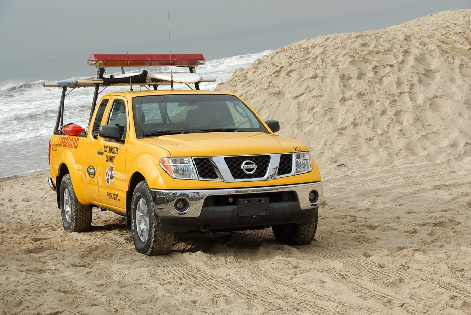 A yellow Nissan Frontier drives down the beach like a mid-size truck.