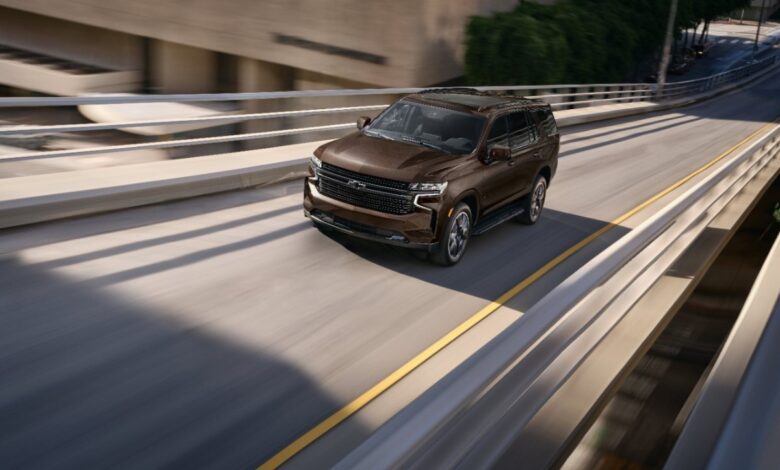 A brown 2023 Chevy Tahoe LT driving on a highway, what are the standard features?