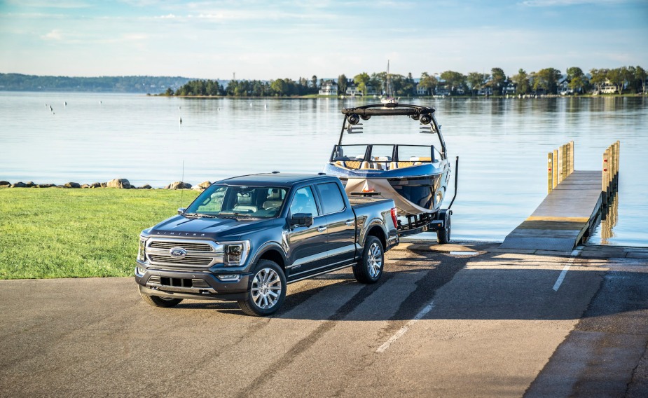 Ford F-150 Hybrid truck pulls a boat out of the water.