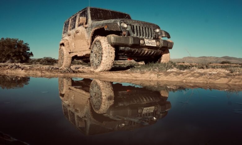 Jeep Wrangler covered in mud while off-roading