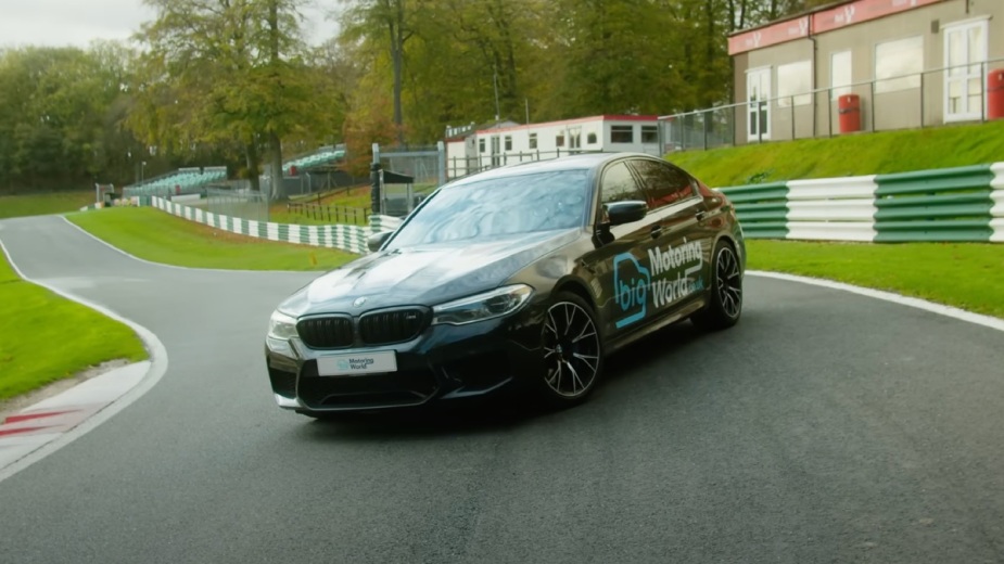 Black BMW M5 Competition, which sprinted at 110 mph on the Cadwell Park track for a job interview