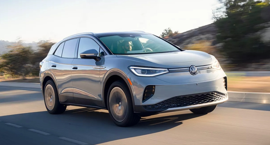 A small gray Volkswagen ID.4 electric SUV from 2023 is driving on the road. 