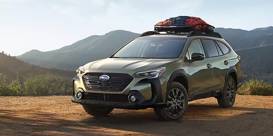 A green 2023 Subaru Outback SUV is parked outdoors. 