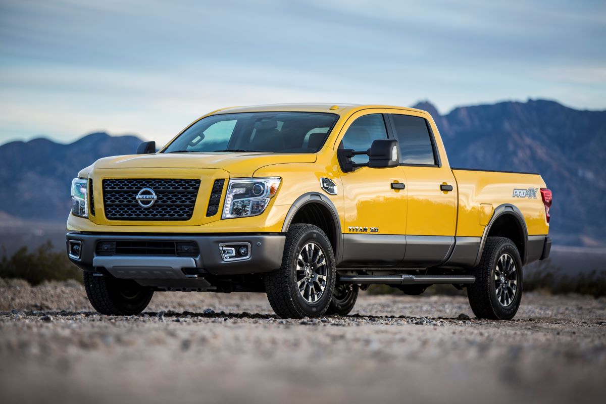 Yellow Nissan Titan in front of the mountains