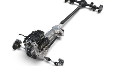 This is the isolated drivetrain of a Ram 1500 pickup truck with axles, transmission, and engine that sometimes suffers coolant leaks against a white backdrop.