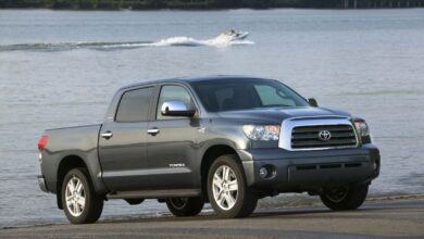 A gray four-door Toyota Tundra parked on a boat ramp, a jet ski visible in the background.