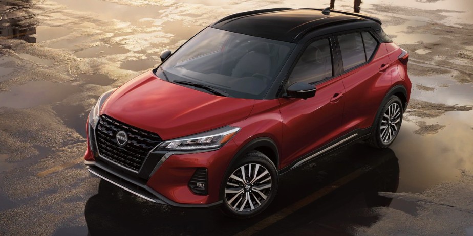 A red 2023 Nissan Kicks compact SUV is parked. 