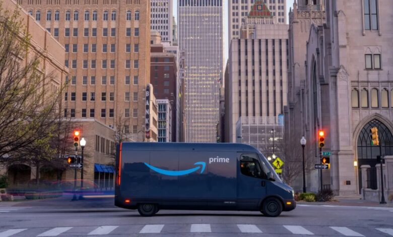 A Rivian Amazon delivery van shows off its unique design in a city.