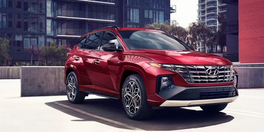 A small red 2023 Hyundai Tucson SUV is parked. 